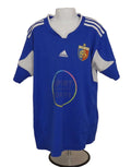 Front view of Adidas Shanghai International football shirt in blue with white mesh panels and crest