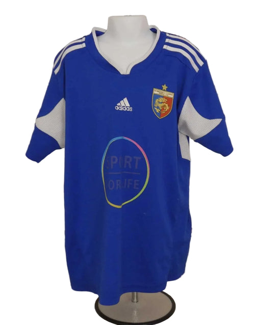 Front view of Adidas Shanghai International football shirt in blue with white mesh panels and crest