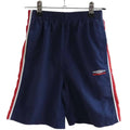 Front view of kids Umbro navy shorts with red and white trim