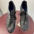 Pair of black Kipsta football boots top view on display stand