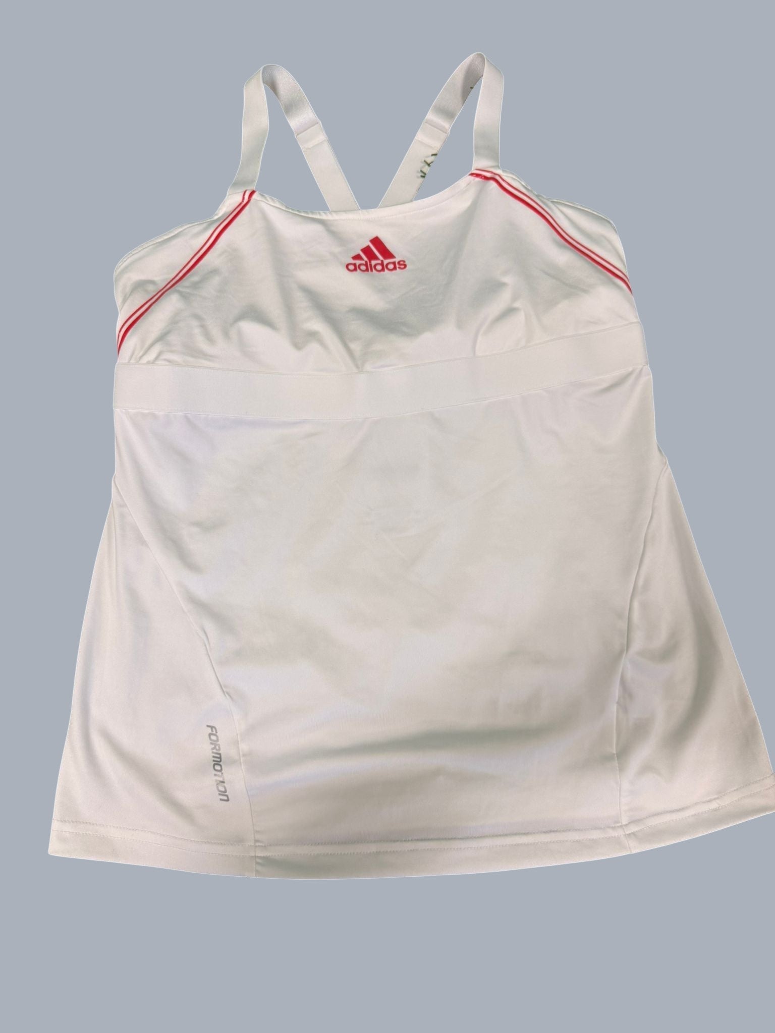 White adidas Barricade women's tennis top with red trim and cross-back straps. Moisture-wicking fabric.