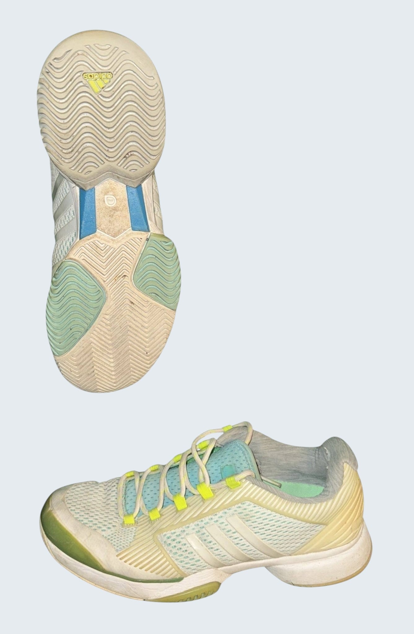 kitround adidas white and light blue mesh tennis shoes with yellow accents and durable sole for stability and grip.