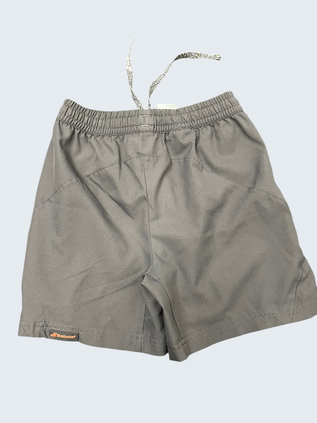 kitround Babolat Kids Grey Training Shorts with elastic waistband and drawstring. Lightweight, breathable fabric for active wear.