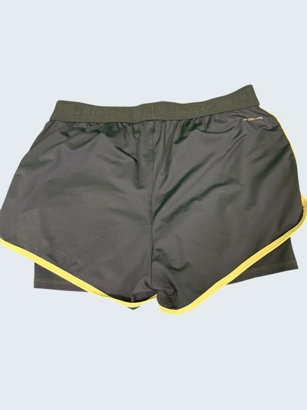 Bjorn Borg dark blue tennis shorts with cream piping and elastic waistband. Lightweight, breathable, moisture-wicking fabric.