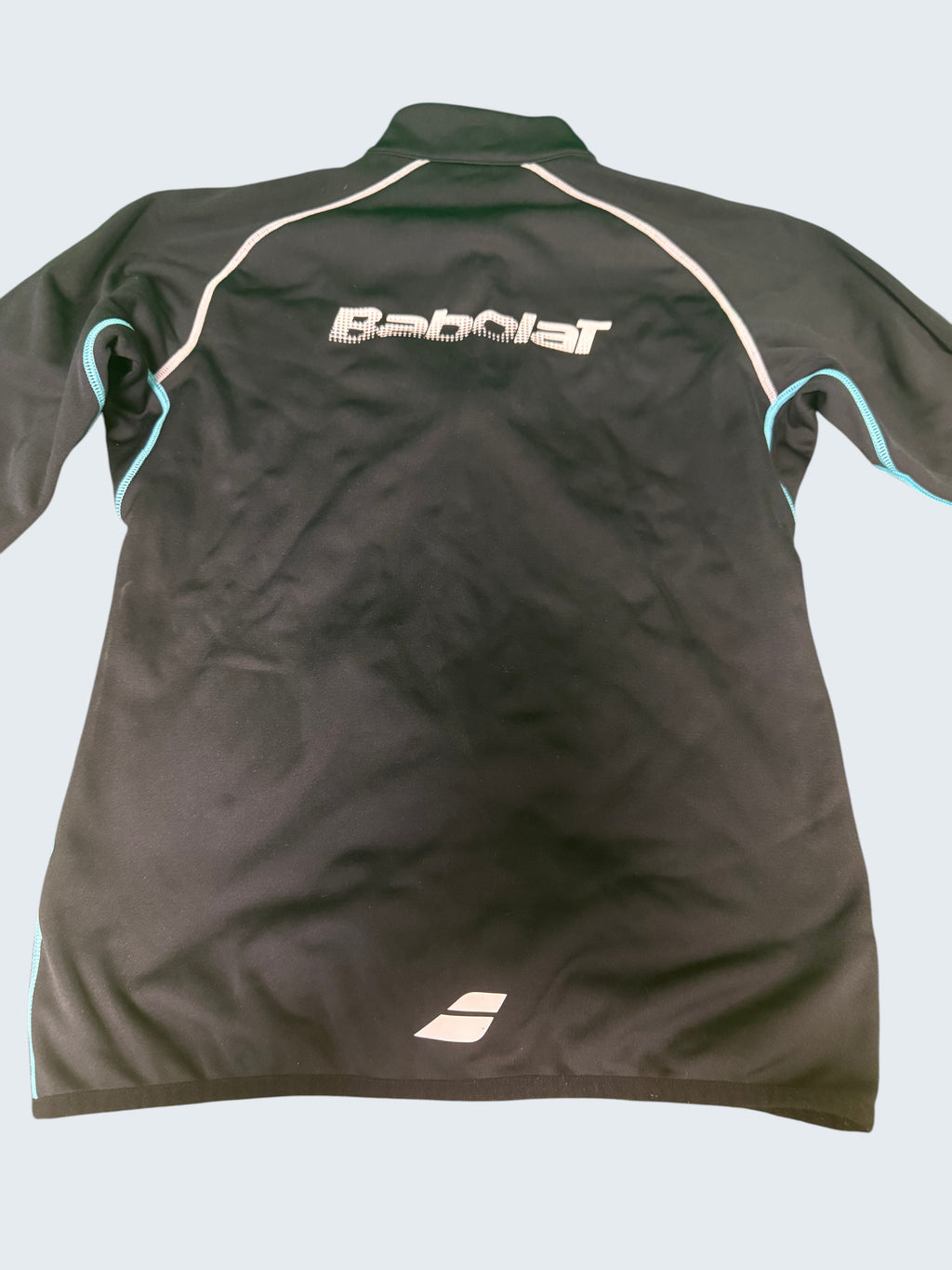 Black Babolat jacket with white and light blue trim. Features a full zip and the Babolat logo on the back.