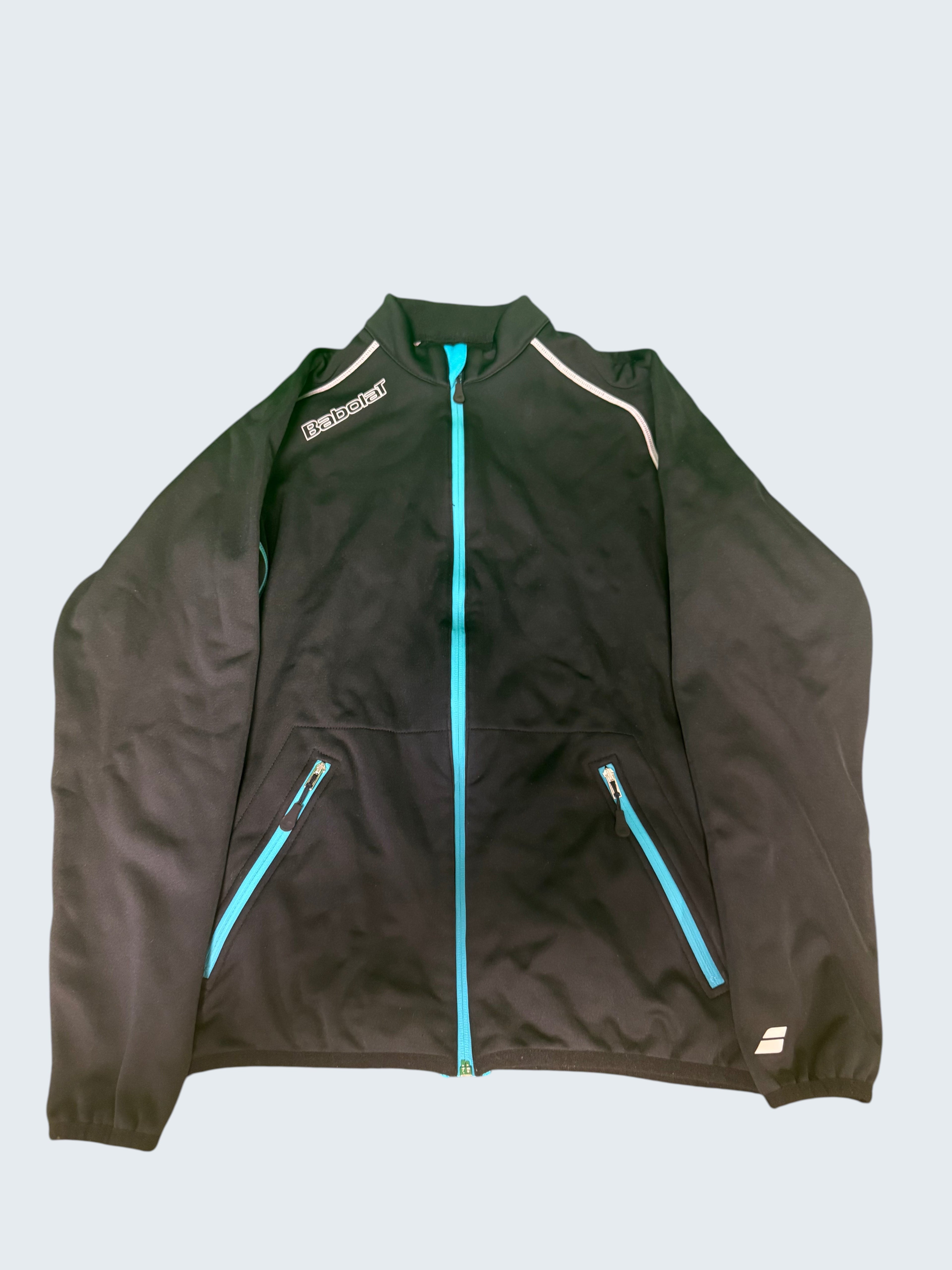 Black Babolat jacket with turquoise zipper and trim, white accents on shoulders, and zippered pockets.