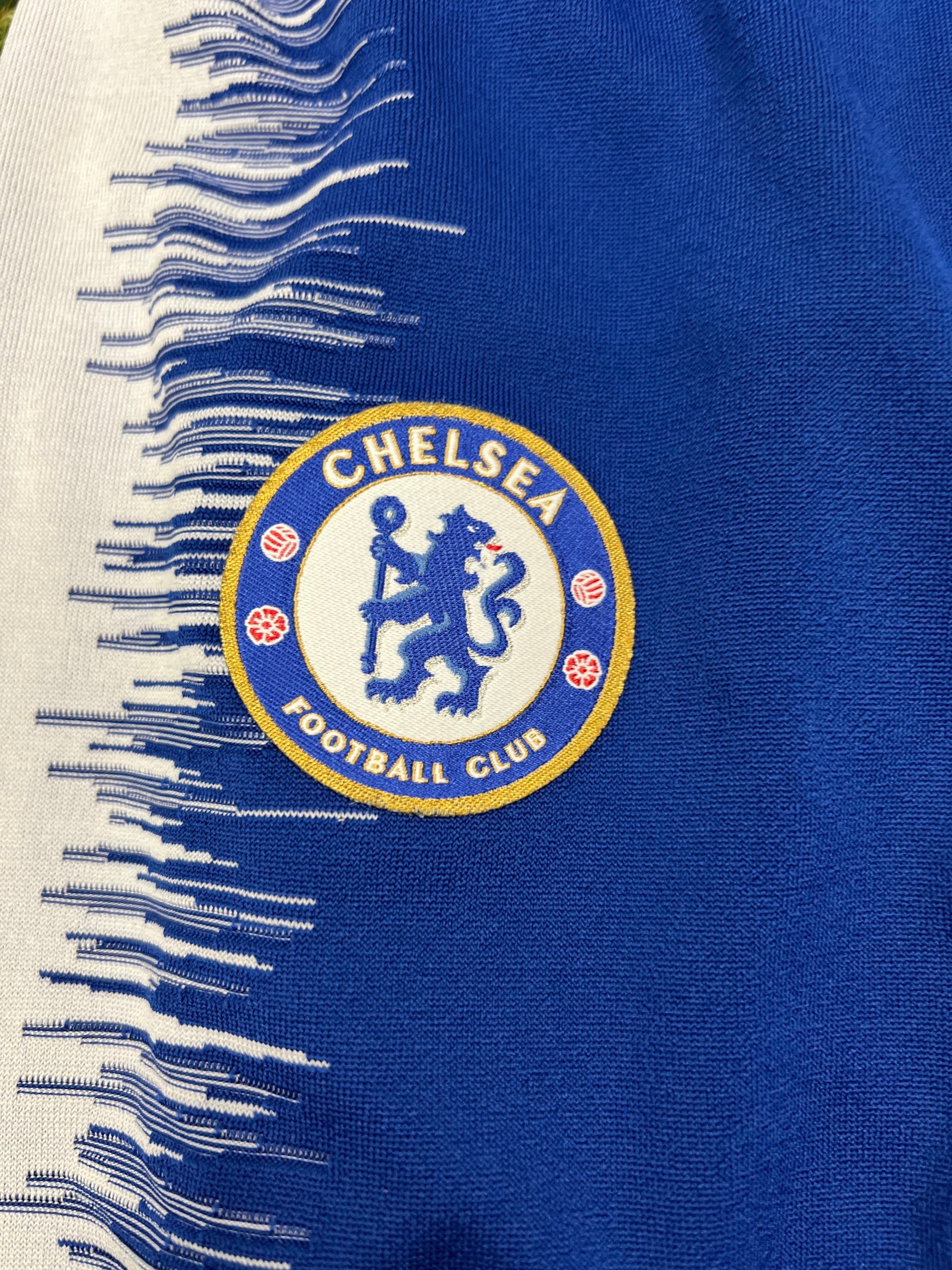 Close-up of Chelsea FC embroidered badge on blue and white textured side panel