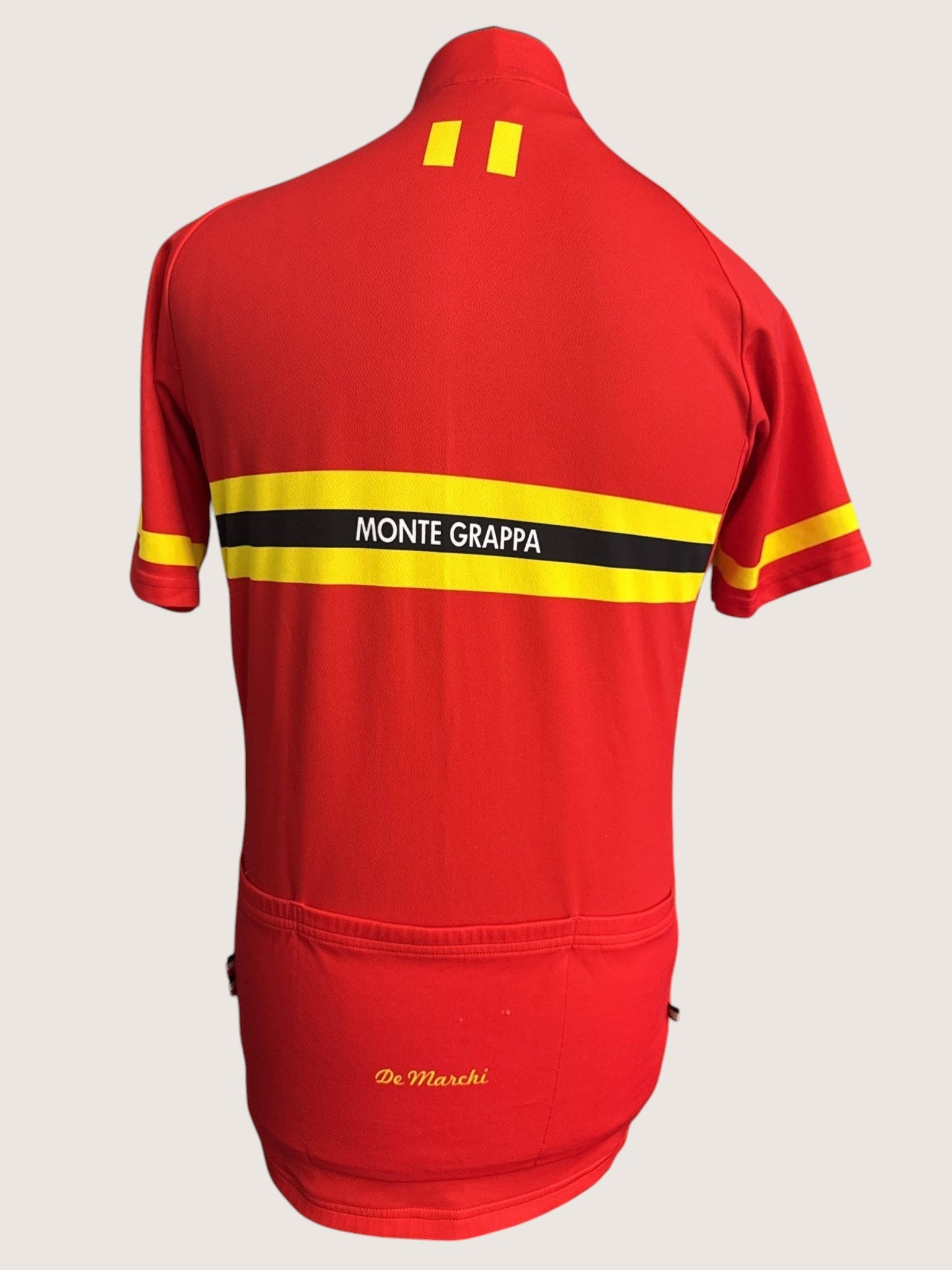 kitround De Marchi red cycling jersey with yellow and black stripes, "MONTE GRAPPA" text, and 3 rear pockets.