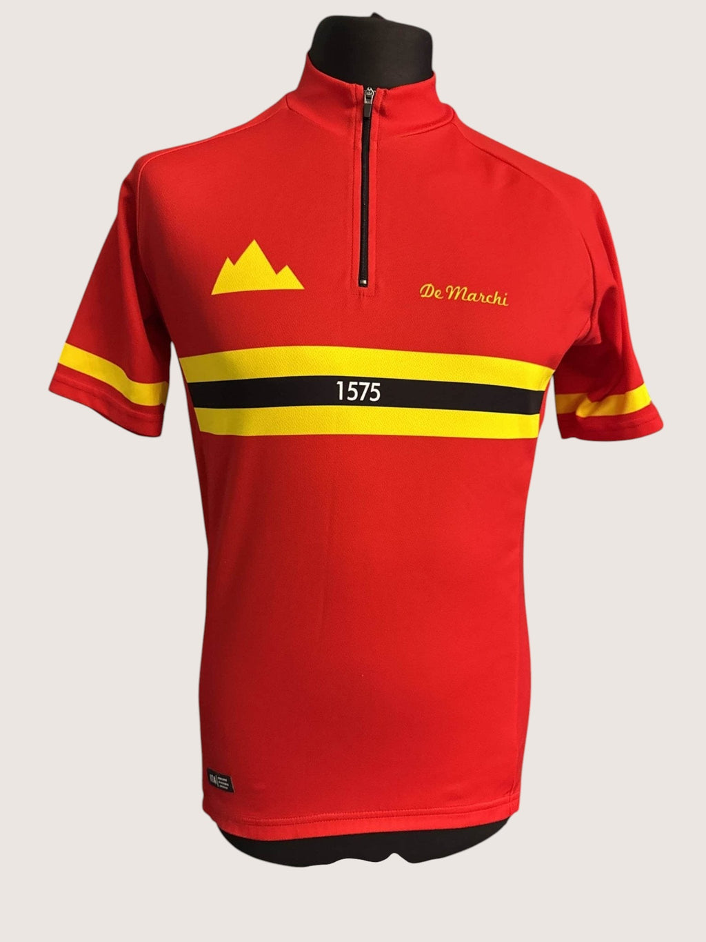 kitround De Marchi red cycling jersey with yellow and black stripes, half-zip front, and mountain logo.