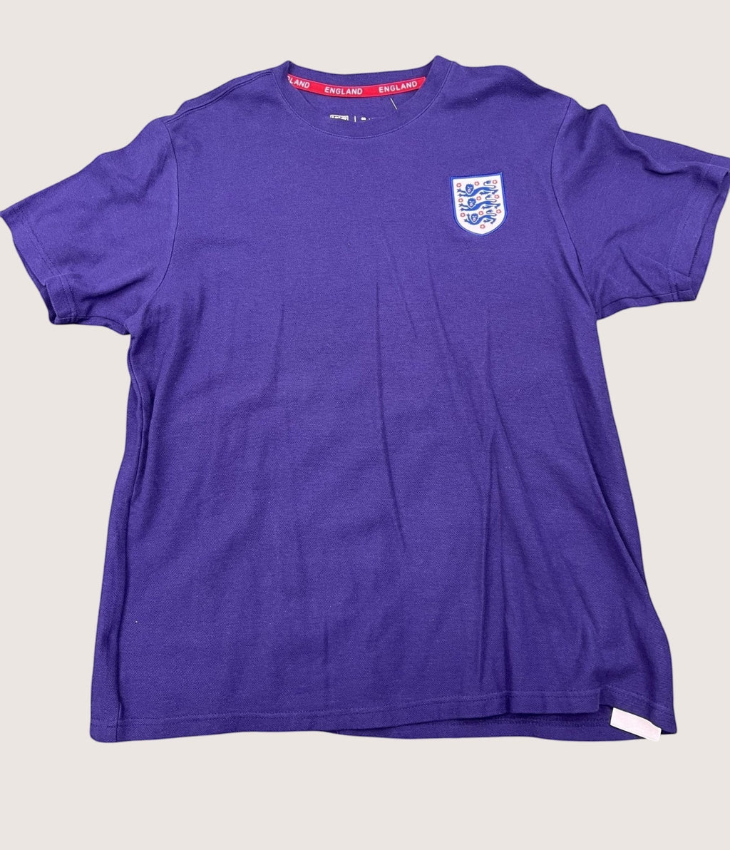 kitround dark blue England football t-shirt with official FA crest and red inner neck detailing on grass background