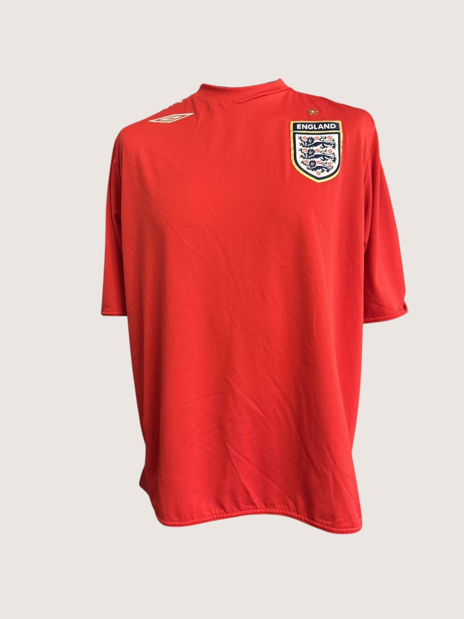 kitround red Umbro England football shirt featuring the iconic three lions badge on a mannequin