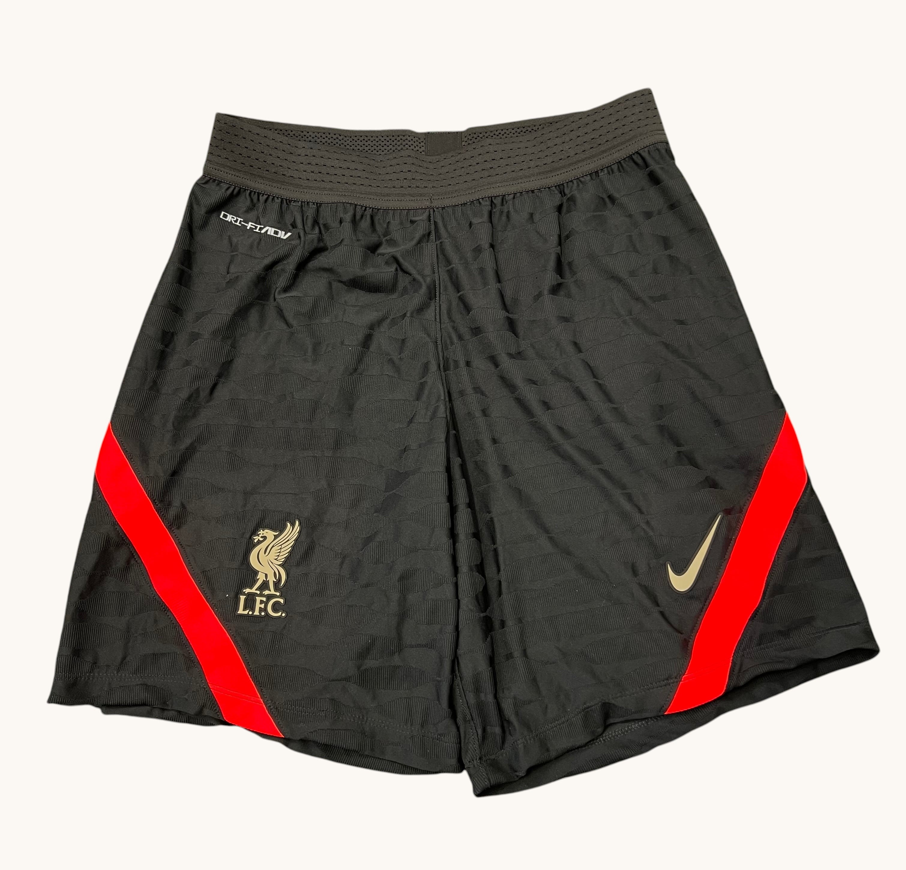kitround Liverpool FC Nike Dri Fit shorts in black with red side stripes and gold LFC and Nike logos. Squad worn.