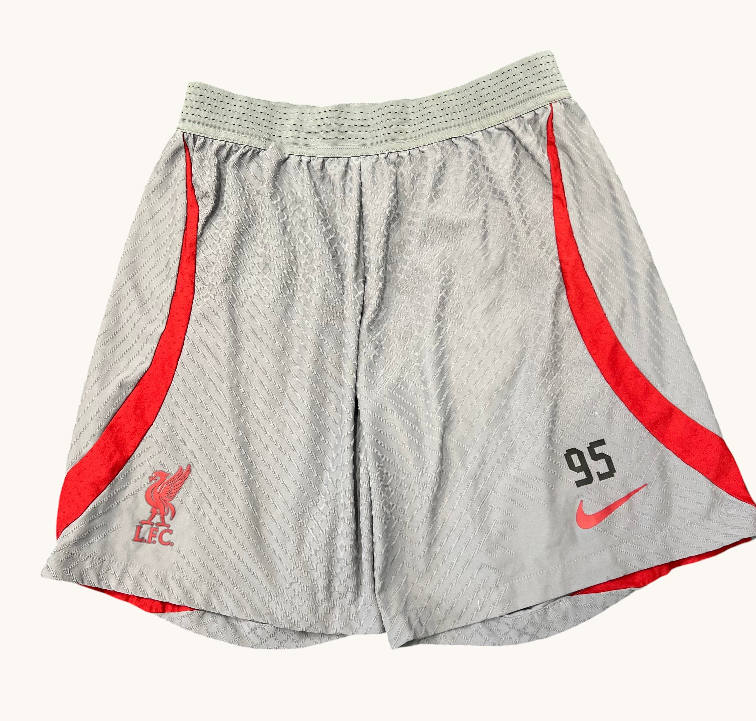 Kitround Liverpool FC Nike Dri Fit shorts in light grey with red trim. Features LFC crest and Nike logo. Squad worn with number 95.