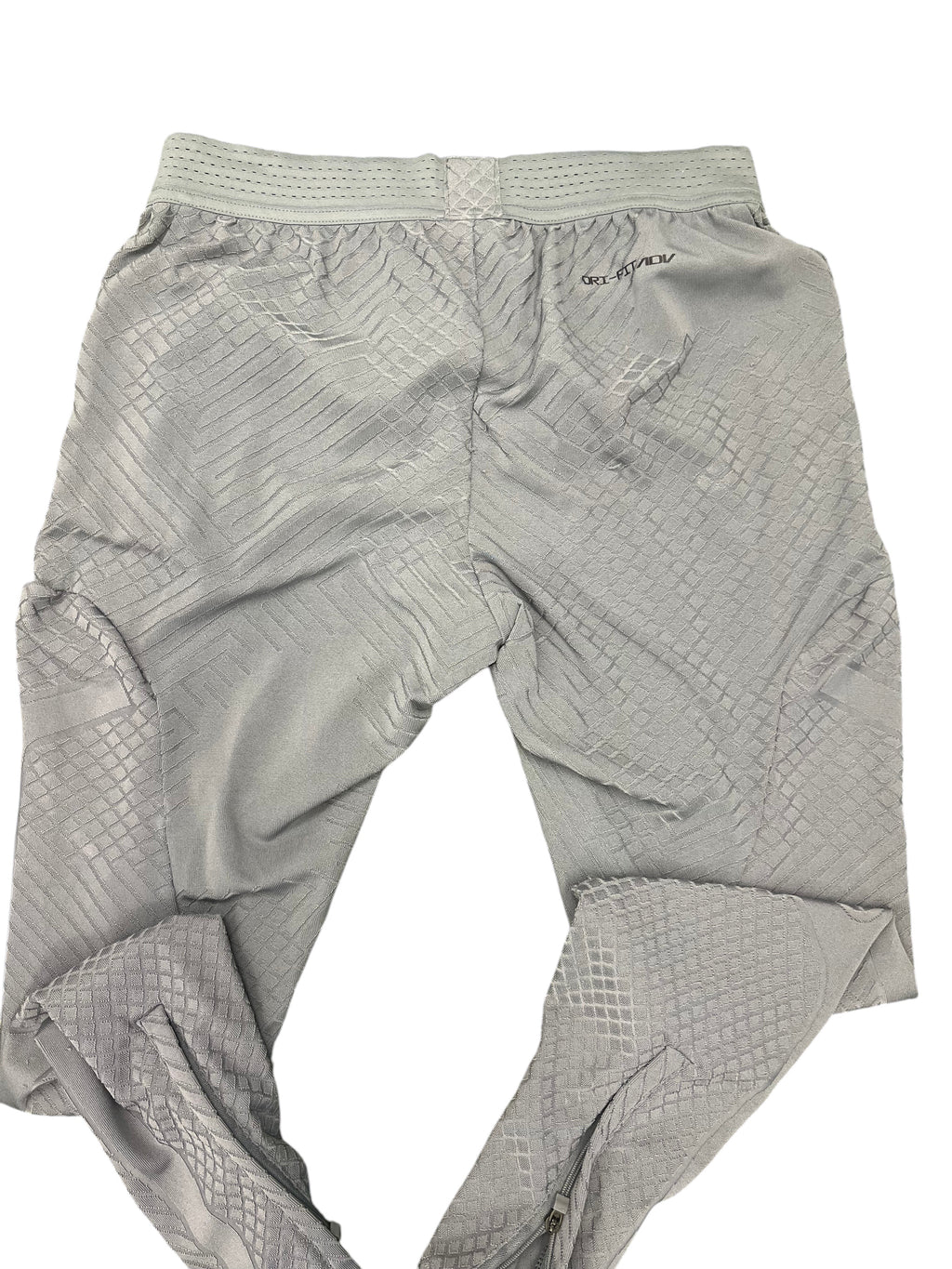 kitround Liverpool FC men's grey training bottoms with Dri-FIT ADV technology and geometric pattern. Zipped ankles.
