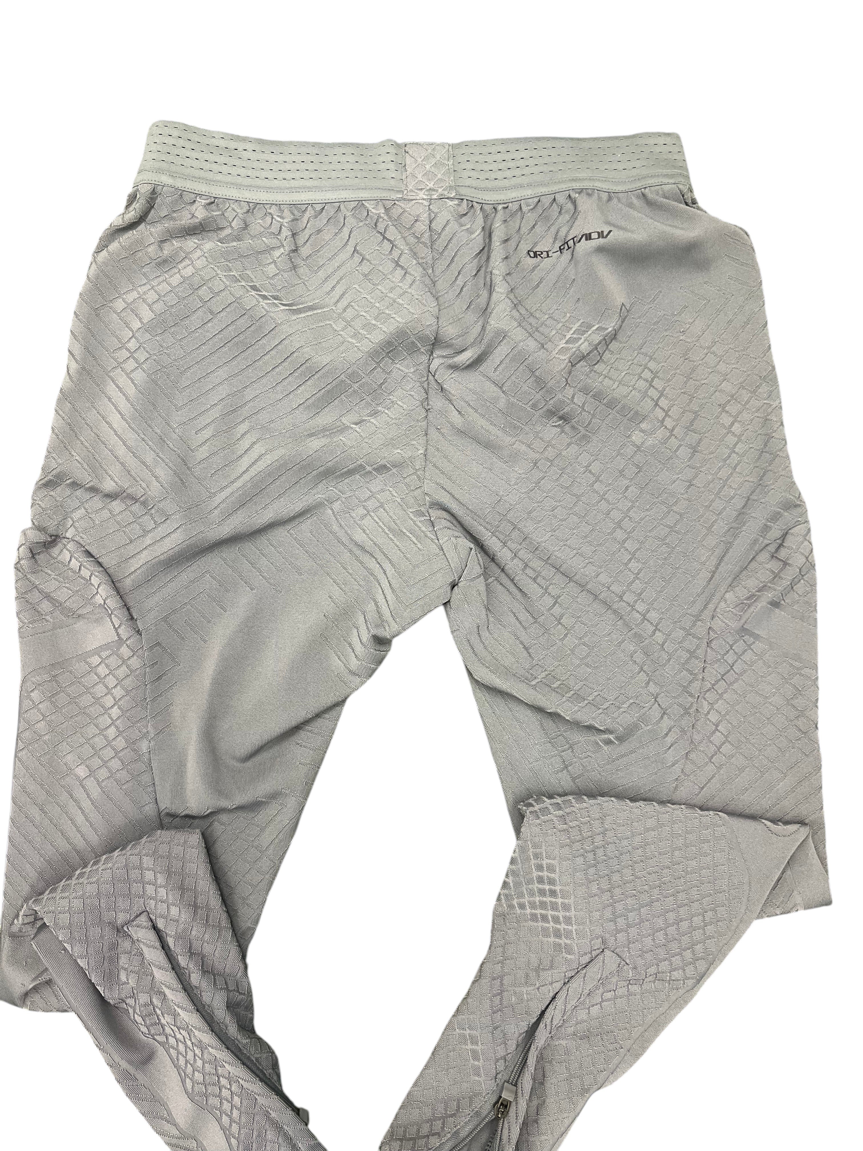 kitround Liverpool FC men's grey training bottoms with Dri-FIT ADV technology and geometric pattern. Zipped ankles.