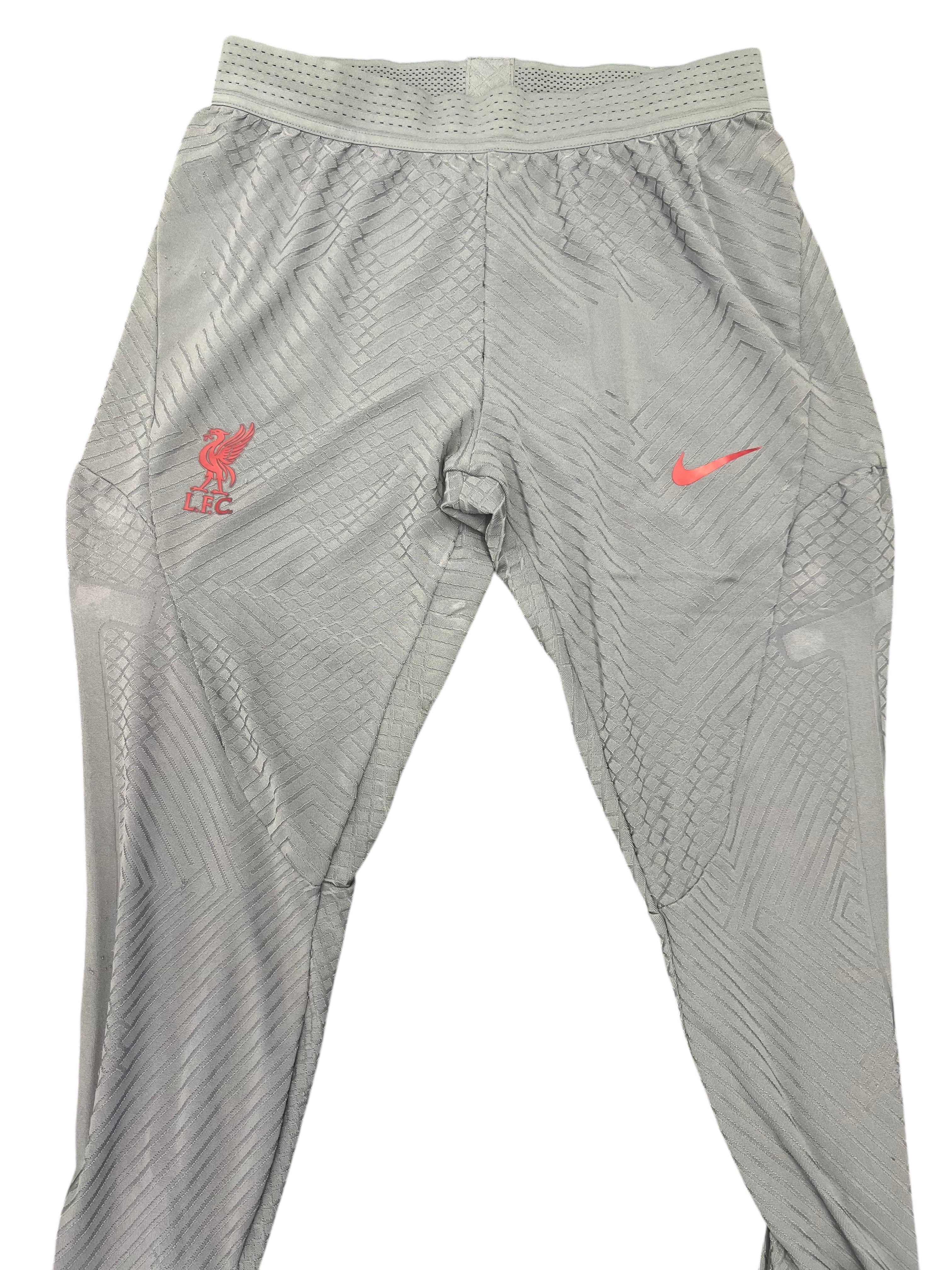 kitround Liverpool FC men's grey polyester elastane training bottoms with red emblem and Nike Swoosh. Textured pattern.