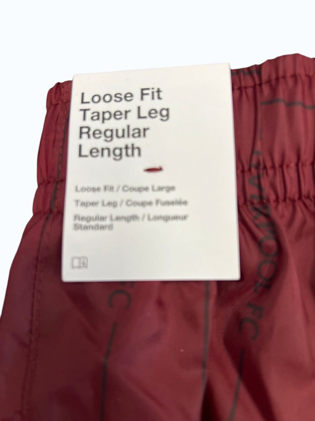 kitround Liverpool FC deep red lightweight loose fit tapered training trousers with subtle all-over print and yellow embroidered crest.