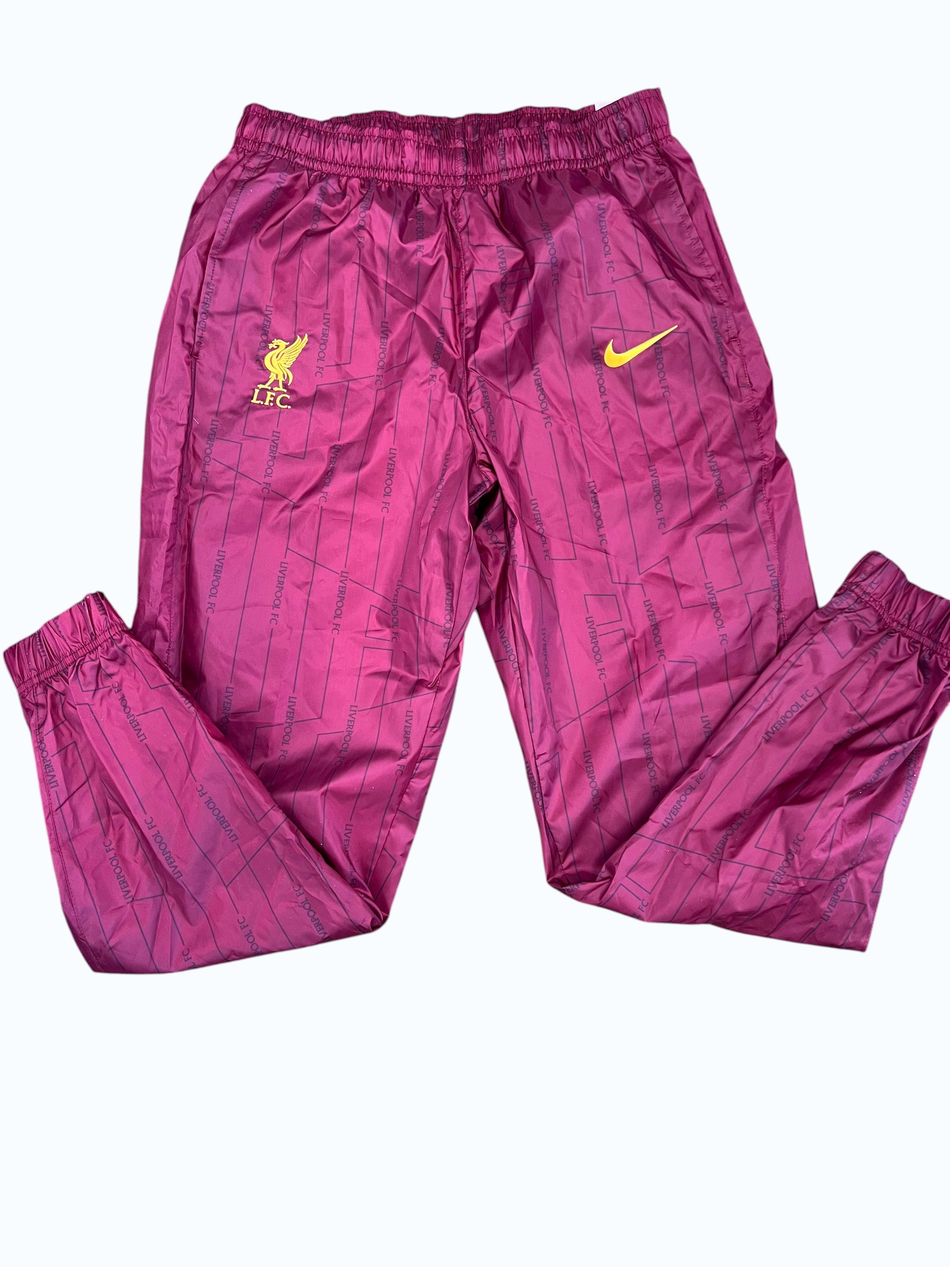 Liverpool FC Nike lightweight training trousers in deep red with all-over subtle print and yellow crest/swoosh embroidery.