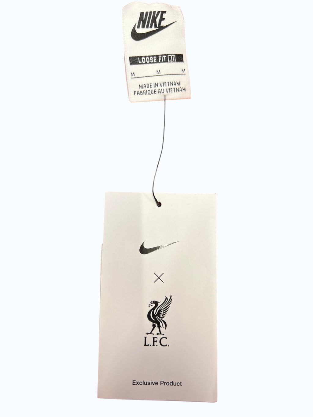 Nike Liverpool FC training trousers, deep red with subtle print, yellow embroidered crest and swoosh. Loose fit, tapered leg.