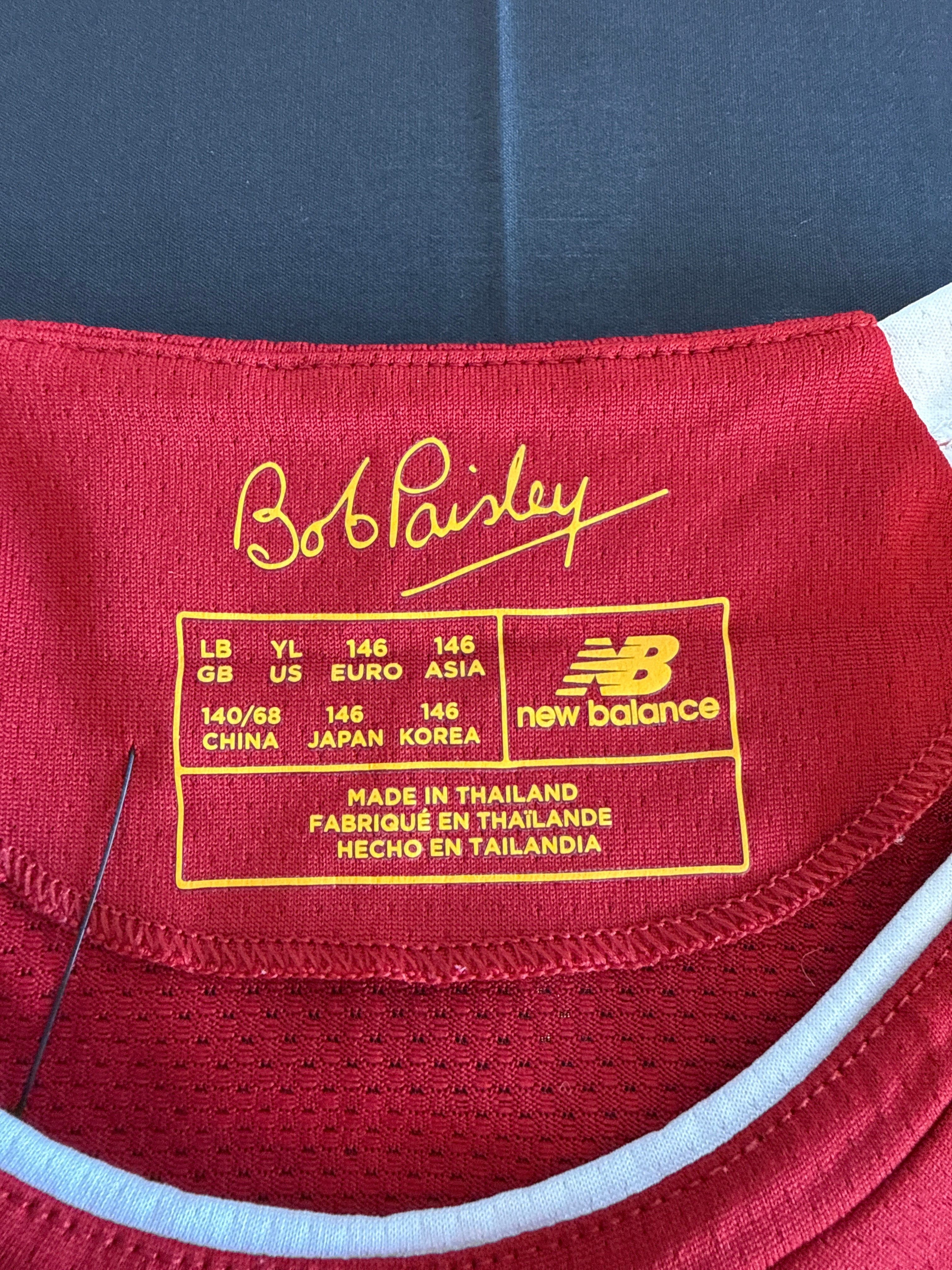 kitround Liverpool home football shirt collar tag with Bob Paisley signature and New Balance logo in red and yellow