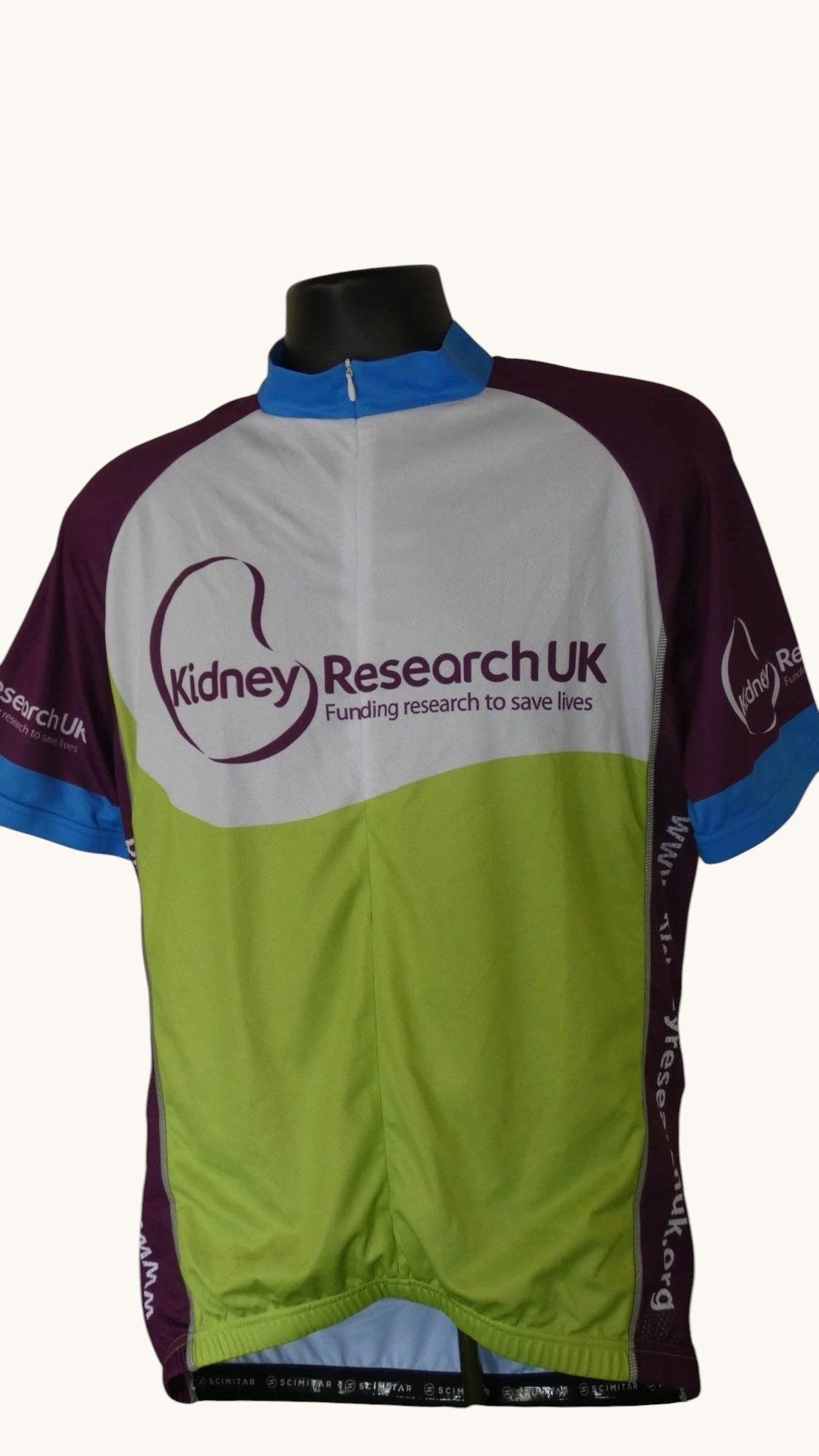 Men's Scimitar cycling top in white, purple, lime green, and blue with Kidney Research UK logo. Features a zip neck and 3 back pockets.