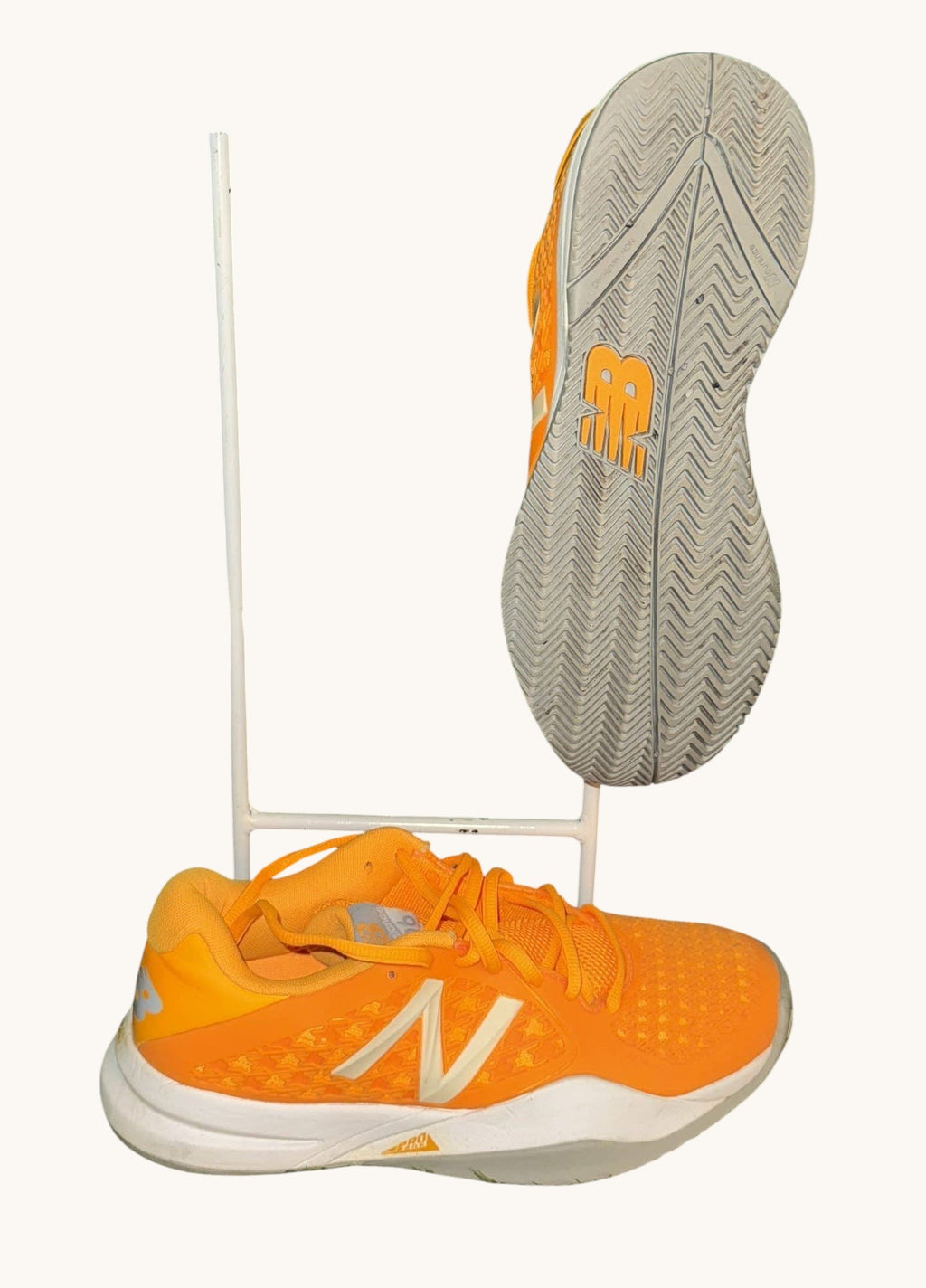 kitround New Balance orange tennis shoes with white accents and herringbone sole pattern. Lightly used.