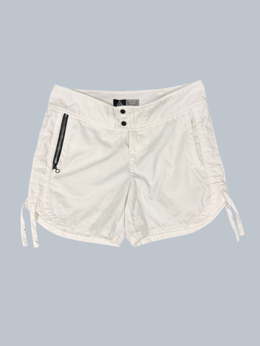 Nike ACG women's white tennis shorts with zip pocket and adjustable hem drawstrings. Size 6.