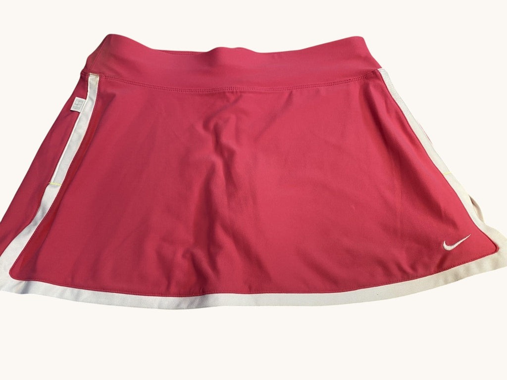 kitround Nike pink tennis skirt with white trim and swoosh logo, lightweight and breathable fabric for comfort and movement.