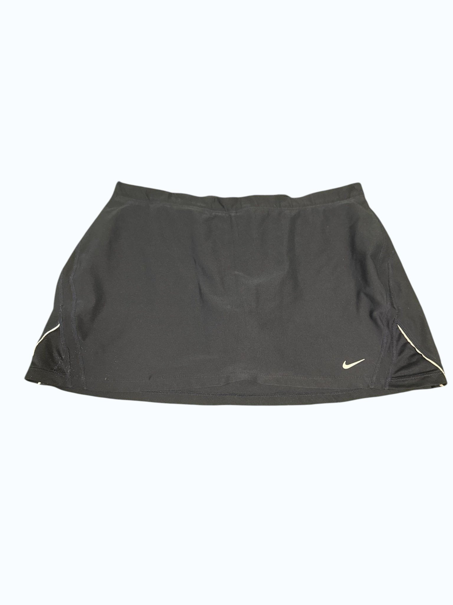 Black Nike tennis skort with white trim and Nike logo, designed for comfort and mobility.