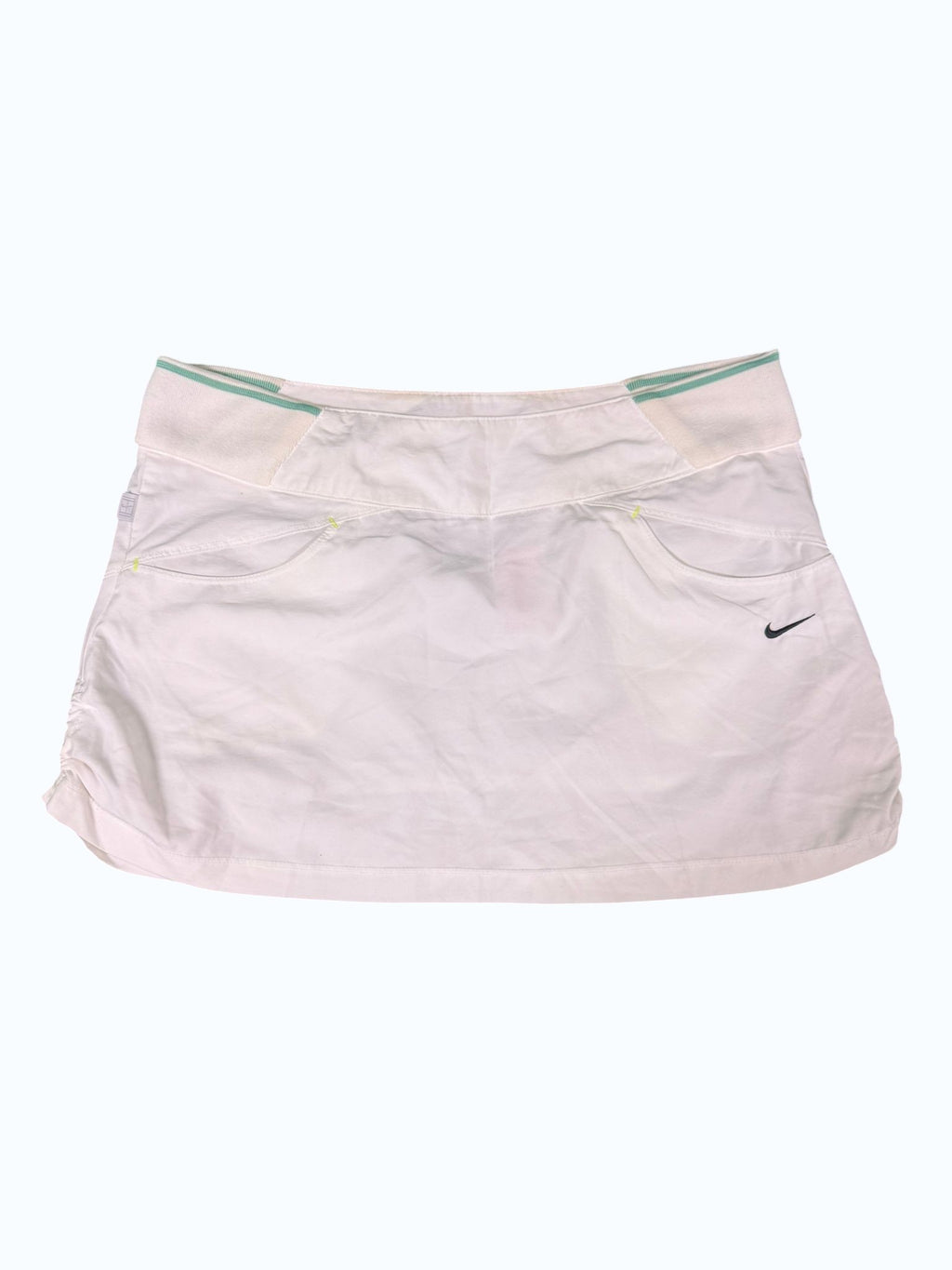 Nike white tennis skirt with side pockets and green striped waistband. Lightweight and breathable fabric.