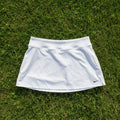 Nike white tennis skirt for women, size S, made of breathable fabric with a subtle swoosh logo.
