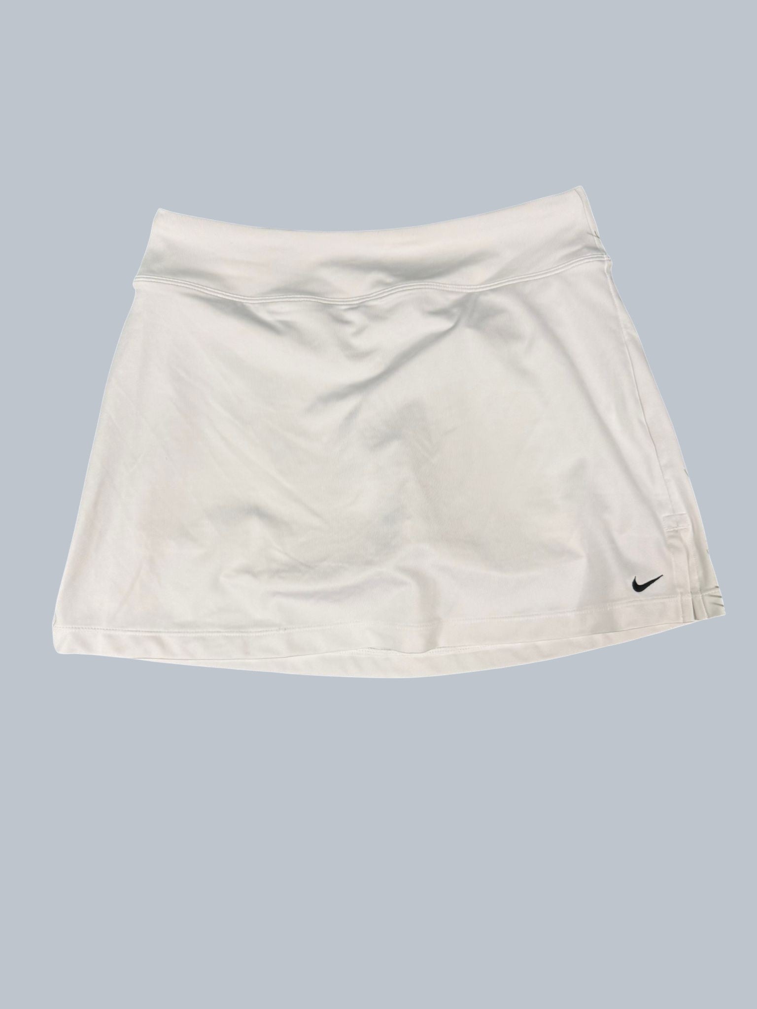 Nike white tennis skirt for women, size S, made of breathable fabric with a subtle swoosh logo.