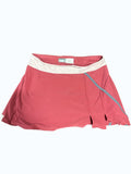 Nike Women's pink tennis skirt with a light cream waistband and blue trim. Features include side slits and a comfortable, flexible design.