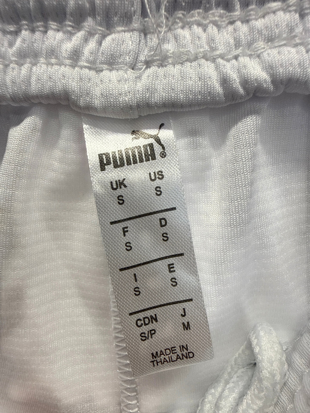 kitround Puma white football shorts interior size tag with branding and manufacturing details