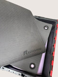 kitround Recharge black yoga mat with textured grip surface and reinforced eyelets for storage and transport.