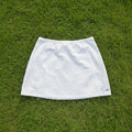 Reebok women's white A-line tennis skirt with subtle stitching and logo detail. Size M.