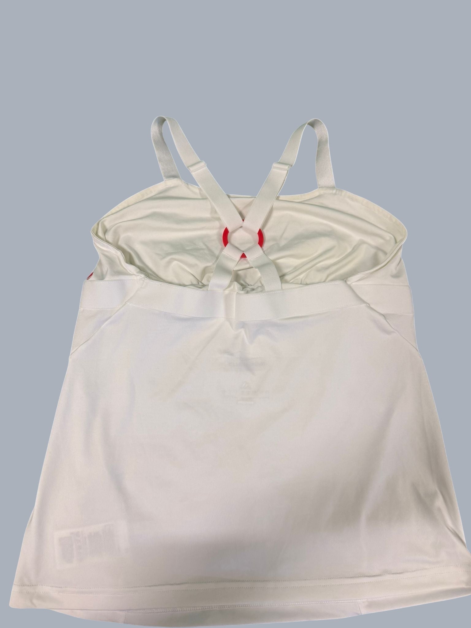 White adidas Barricade women's tennis top with red strap detail and adjustable cross-back straps.
