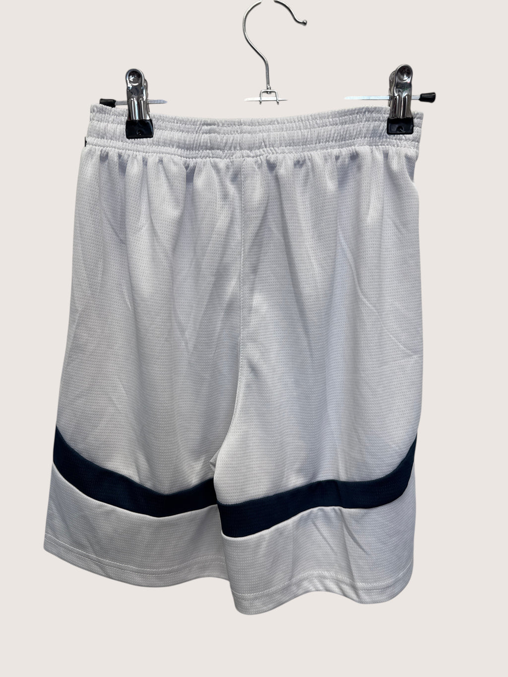 kitround white Puma Manchester City football shorts with navy blue trim and elastic waistband, back view.
