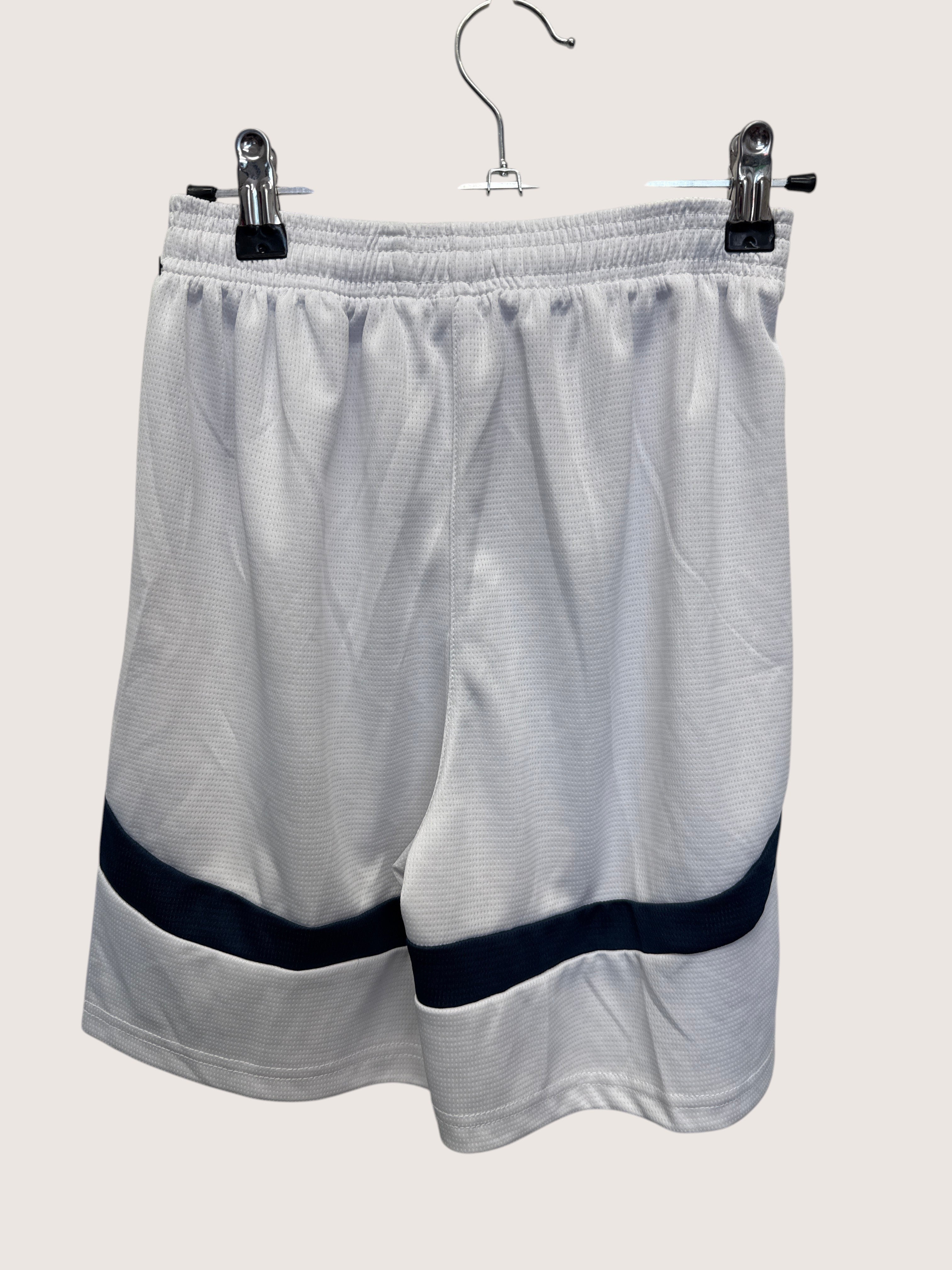 kitround white Puma Manchester City football shorts with navy blue trim and elastic waistband, back view.