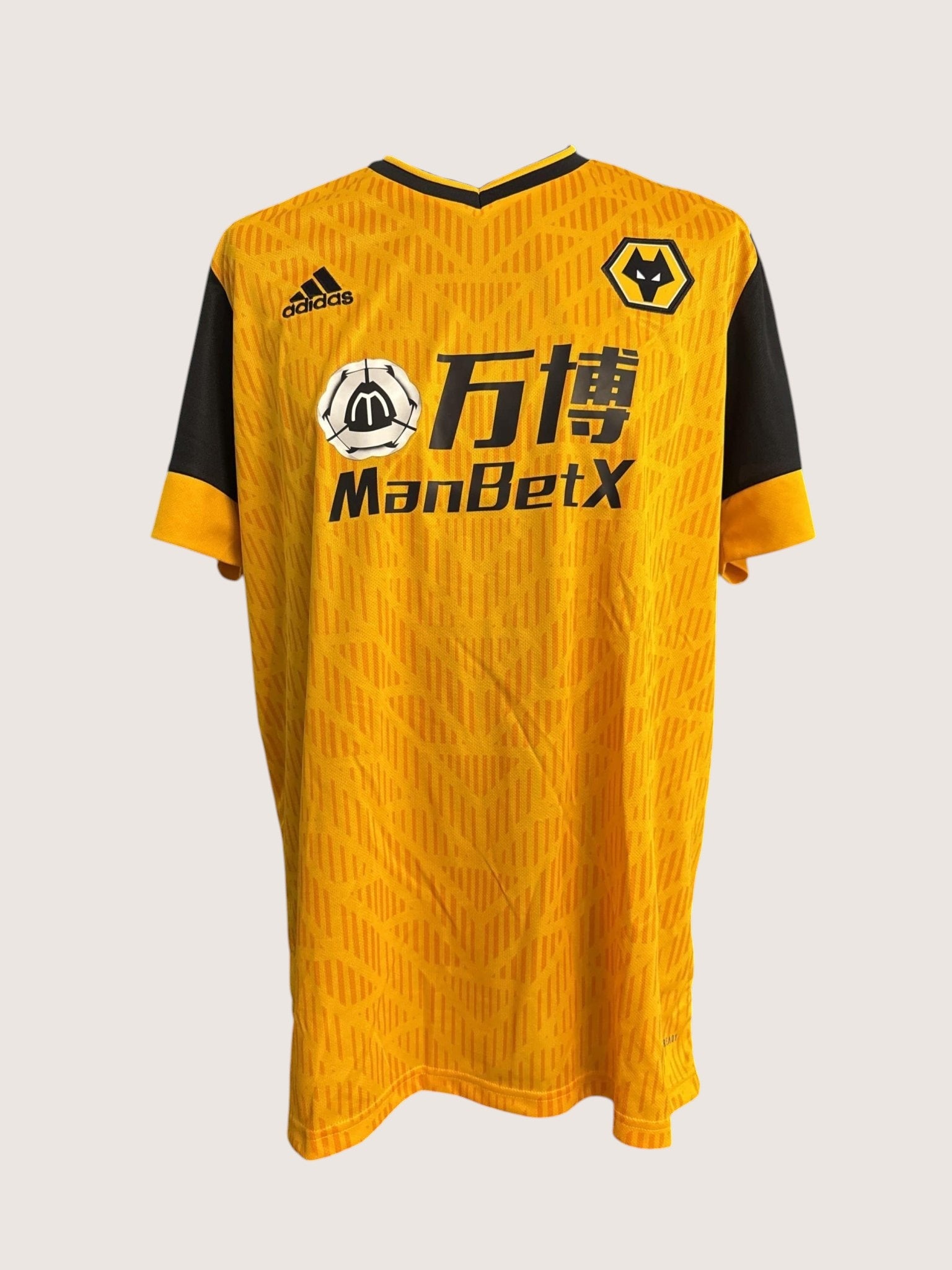 Front view of an orange and black adidas Wolves football shirt with ManBetX sponsor branding and club crest.