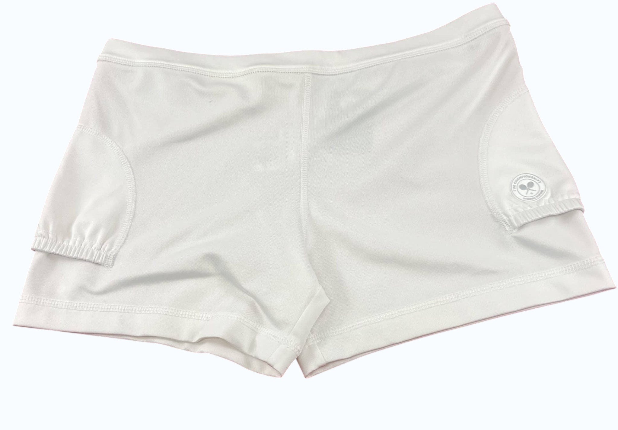 kitround Women's white tennis shorts with discreet logo emblem on side, lightweight and breathable fabric.