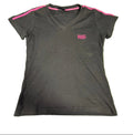 Black Lonsdale V-neck women's T-shirt with pink shoulder stripes and logo, laid flat on green artificial grass.