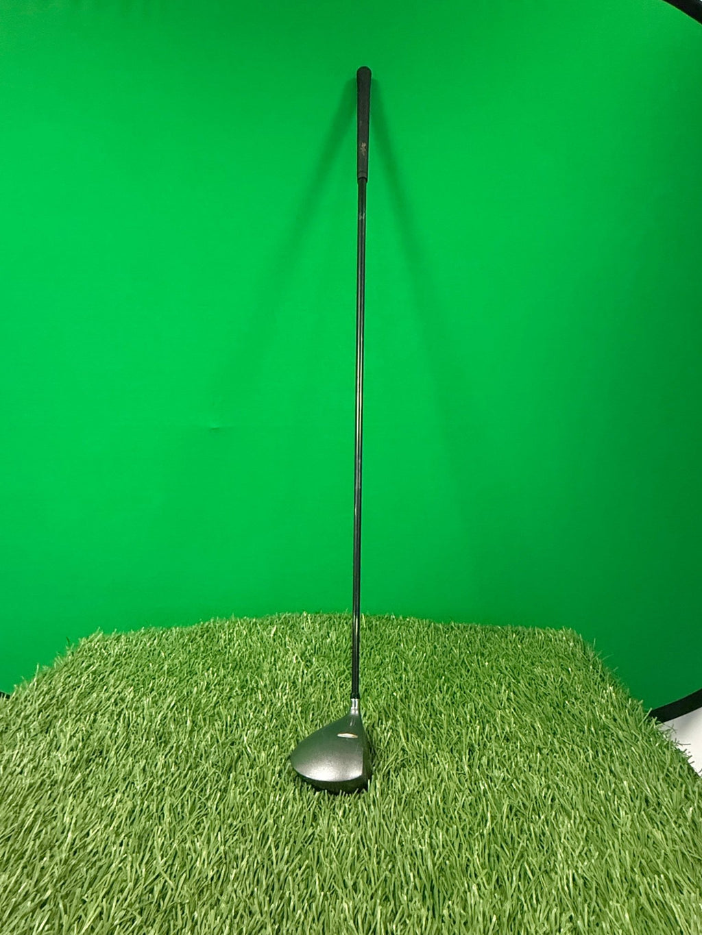 MacGregor oversize 3 wood golf club standing upright on artificial grass with green background