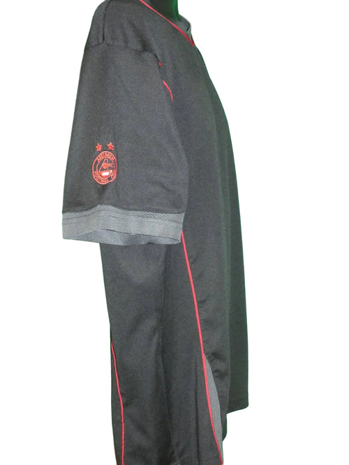 Side view of black Aberdeen FC training top with red piping and club crest on sleeve