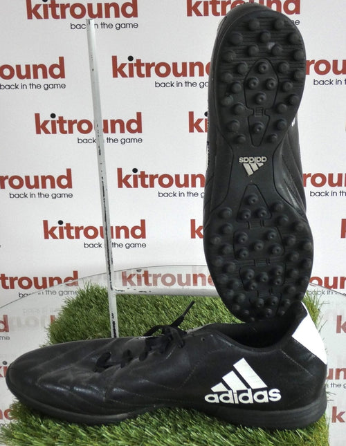 adidas black astro turf football boots with bold white adidas logo, shown side and sole view on artificial grass