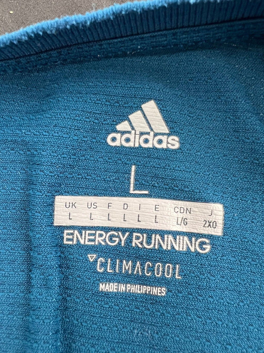 Closeup of adidas Climacool Energy Running t-shirt label showing size and branding