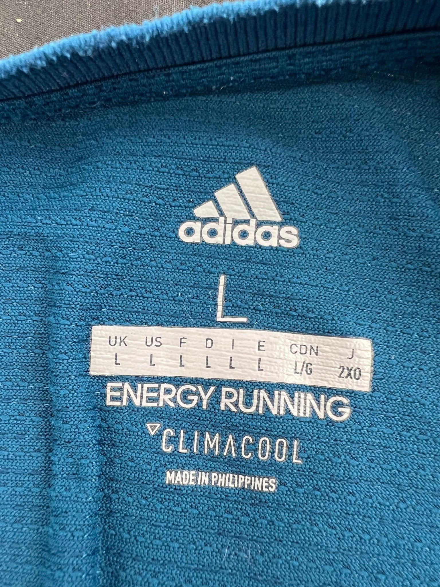Closeup of adidas Climacool Energy Running t-shirt label showing size and branding