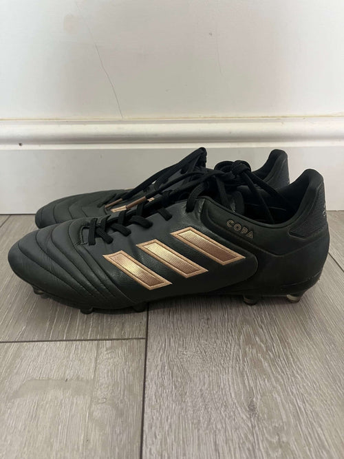 Side view of black adidas football boots with gold adidas stripes and 'COPA' branding
