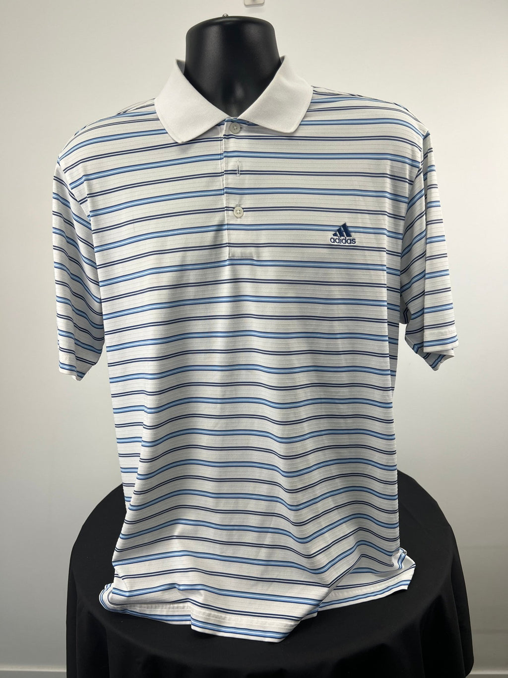 Front of men's adidas golf polo shirt with blue and white stripes