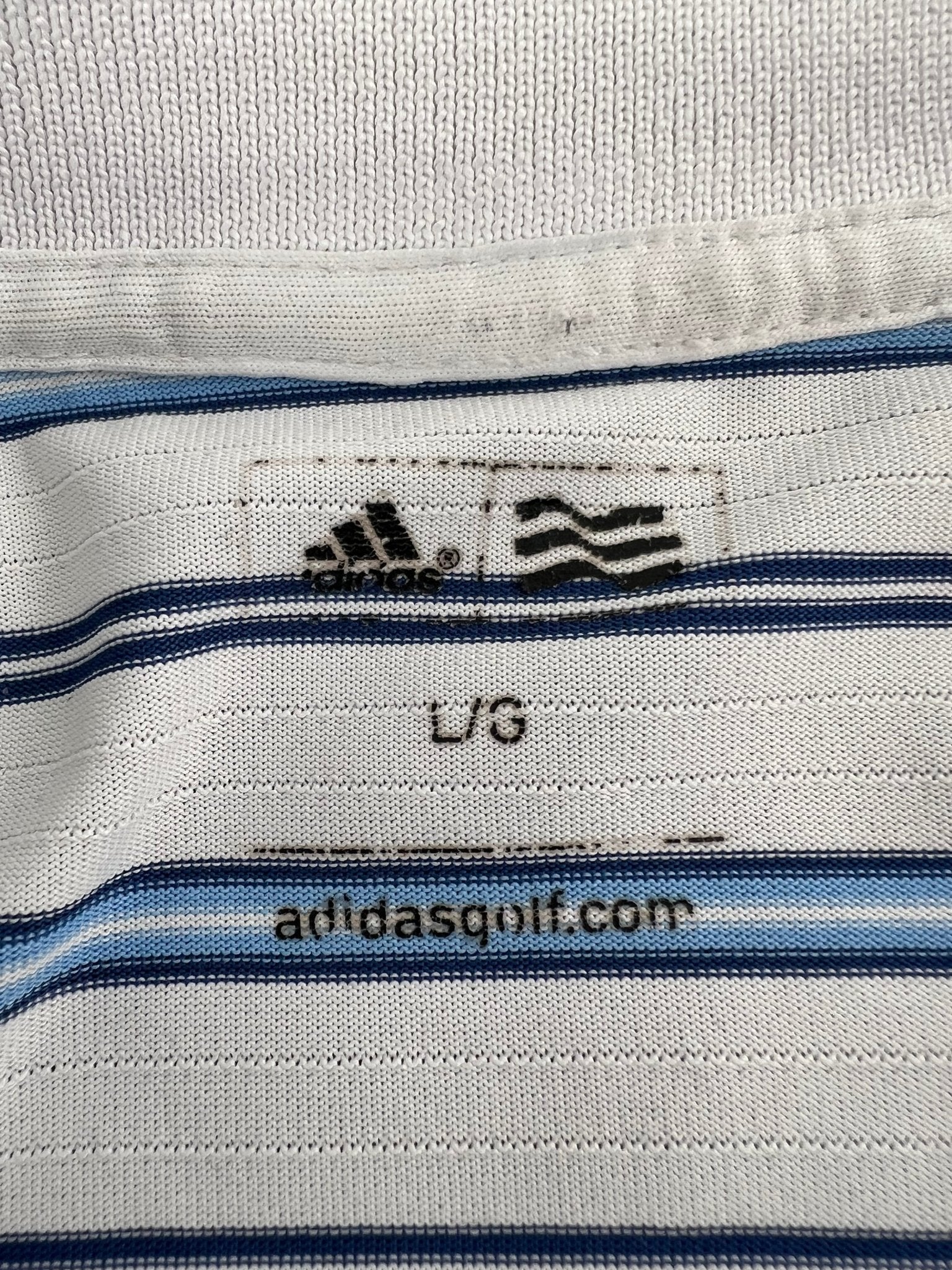 Close-up of size label and adidasgolf.com logo inside collar